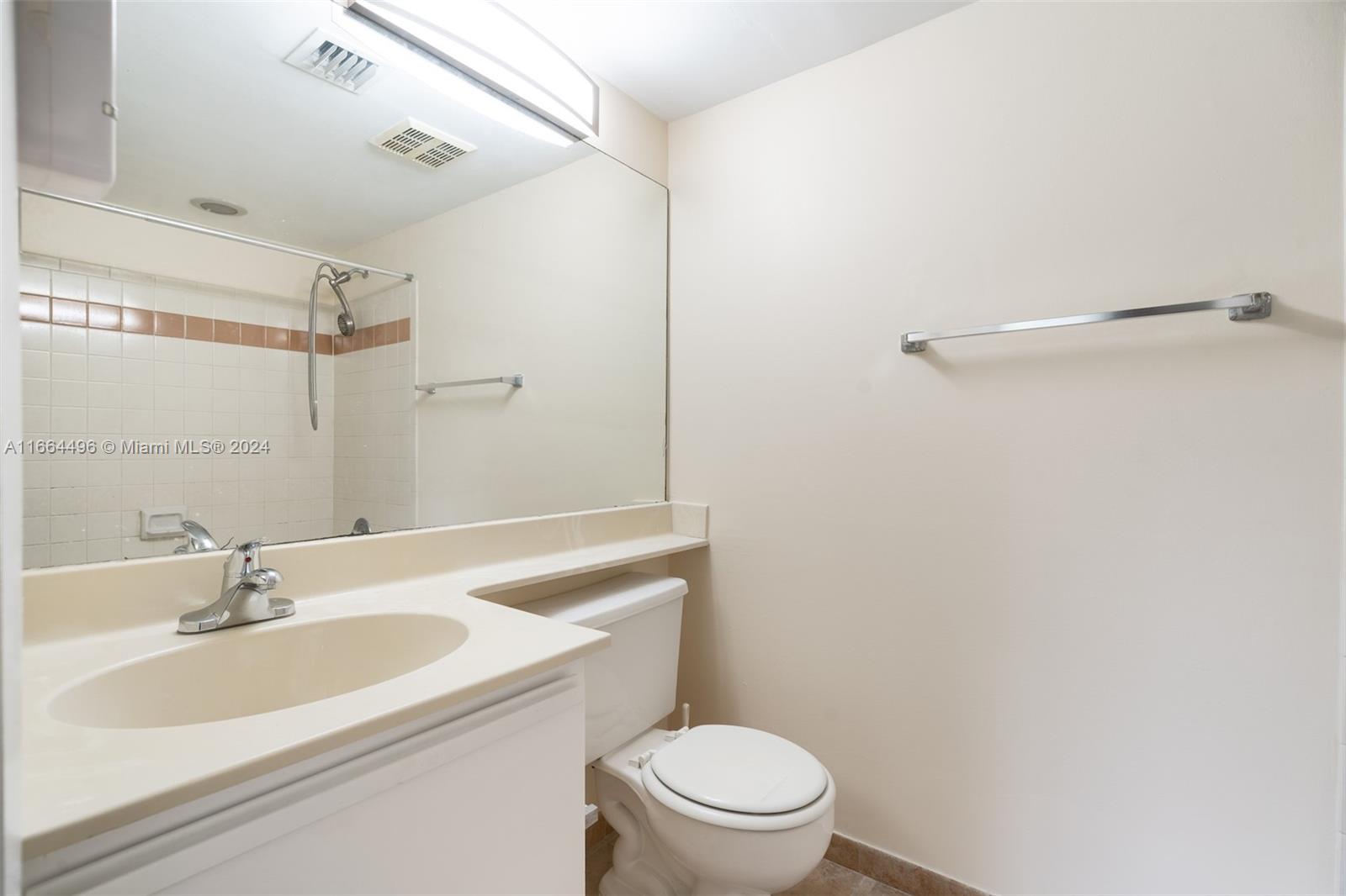5672 Rock Island Road, Unit 259 Tamarac, FL 33319 - Photo 10 of 31 a bathroom with a sink toilet and shower