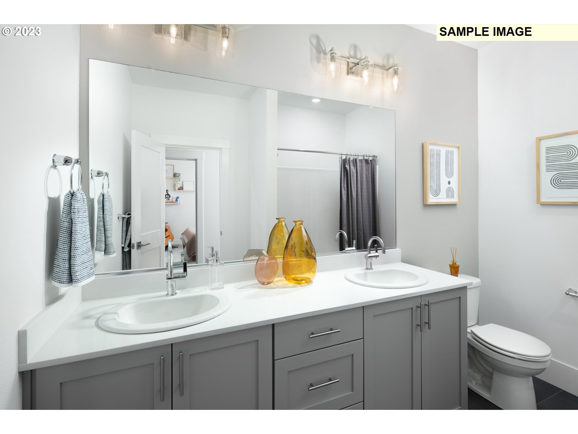 17860 Southwest Maiden Court Beaverton, OR 97007 - Photo 17 of 23 a bathroom with a sink double vanity and a toilet