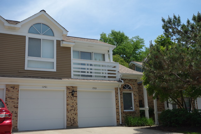 1261 Ranchview Court Buffalo Grove, IL 60089 - Photo 1 of 23 a front view of a house with a garden