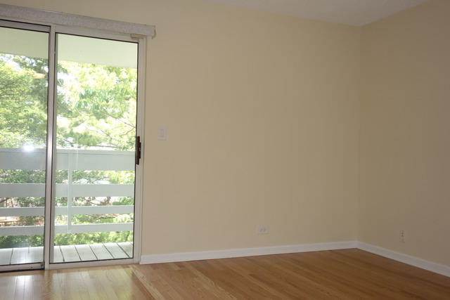 1261 Ranchview Court Buffalo Grove, IL 60089 - Photo 20 of 23 a view of an empty room and wooden floor and a window