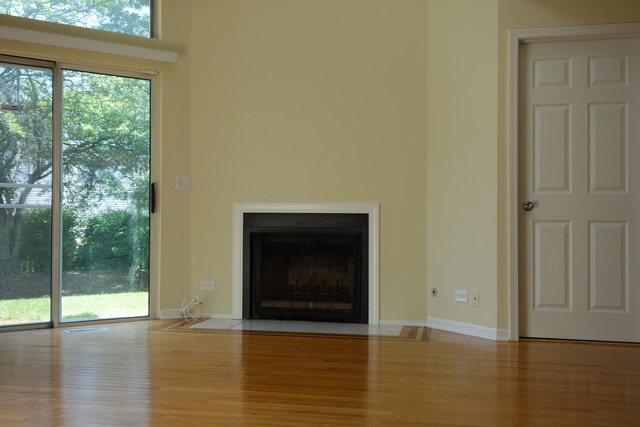 1261 Ranchview Court Buffalo Grove, IL 60089 - Photo 5 of 23 a view of an empty room with wooden floor and a window