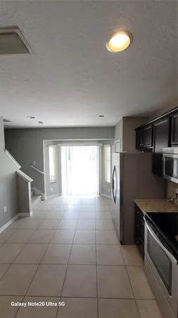 a kitchen with stainless steel appliances a refrigerator and a stove top oven