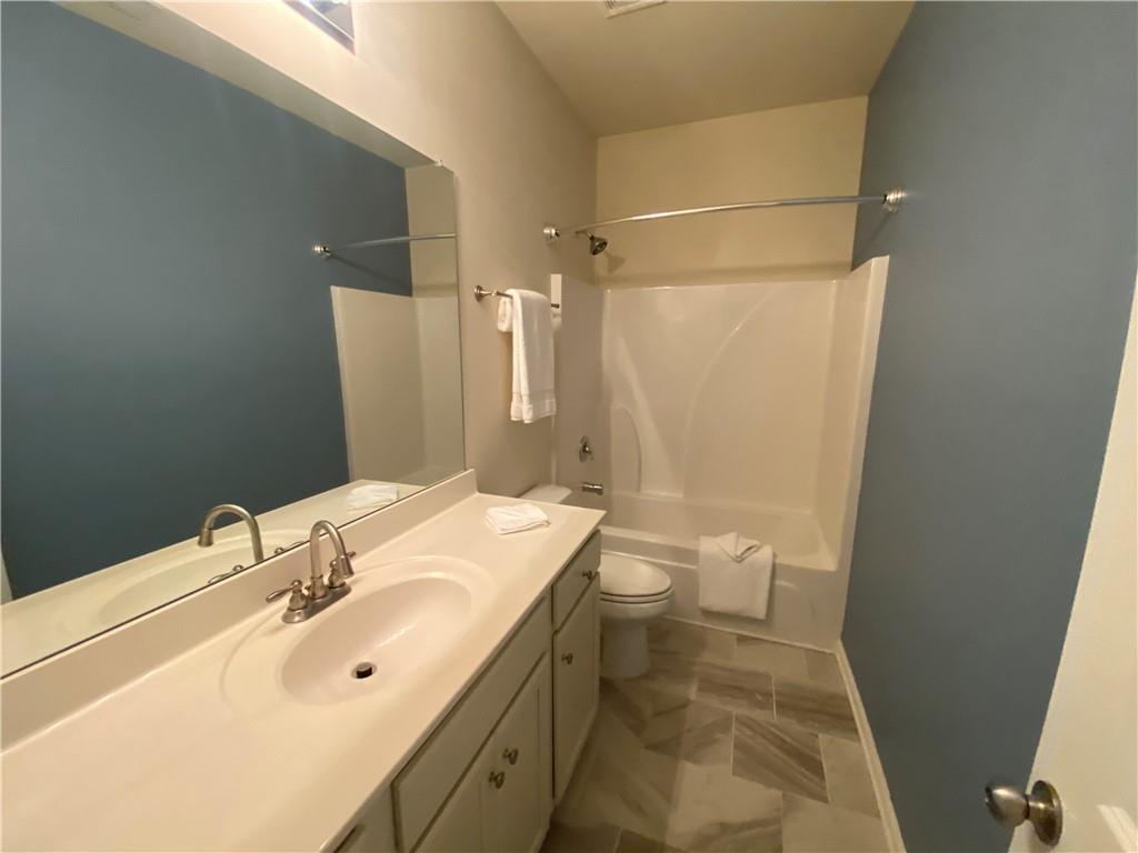 4870 Odum View Lane Cumming, GA 30040 - Photo 12 of 23 a bathroom with a sink and a mirror