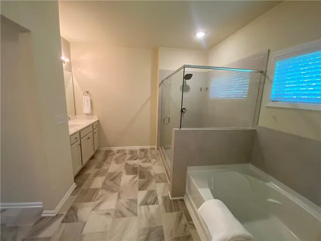 a bathroom with a bathtub and a shower