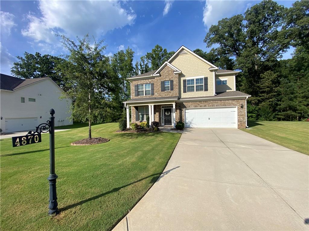 4870 Odum View Lane Cumming, GA 30040 - Photo 2 of 23 a front view of a house with garden