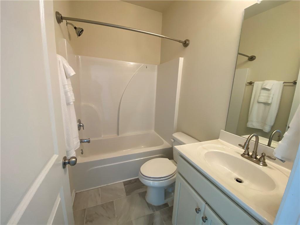 4870 Odum View Lane Cumming, GA 30040 - Photo 8 of 23 a bathroom with a sink toilet and shower