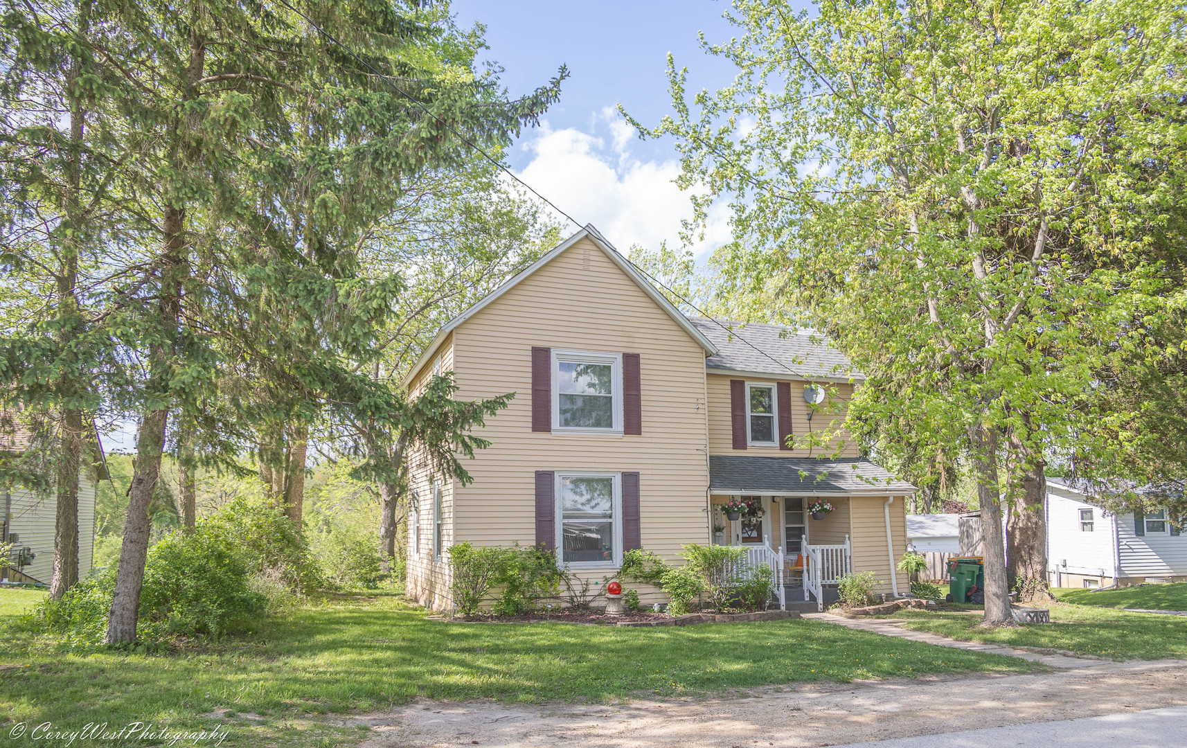 a front view of house with yard and green space