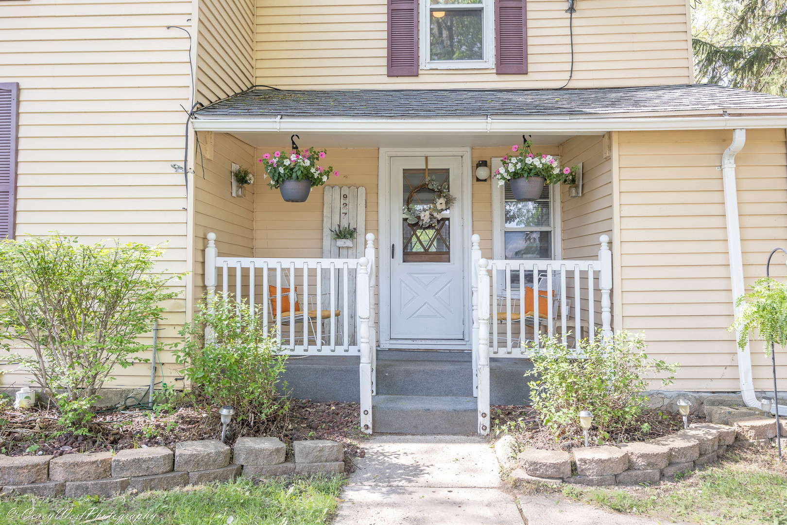 927 Thurlby Road Kingston, IL 60145 - Photo 3 of 21 a view of a house with potted plants and a table and chair