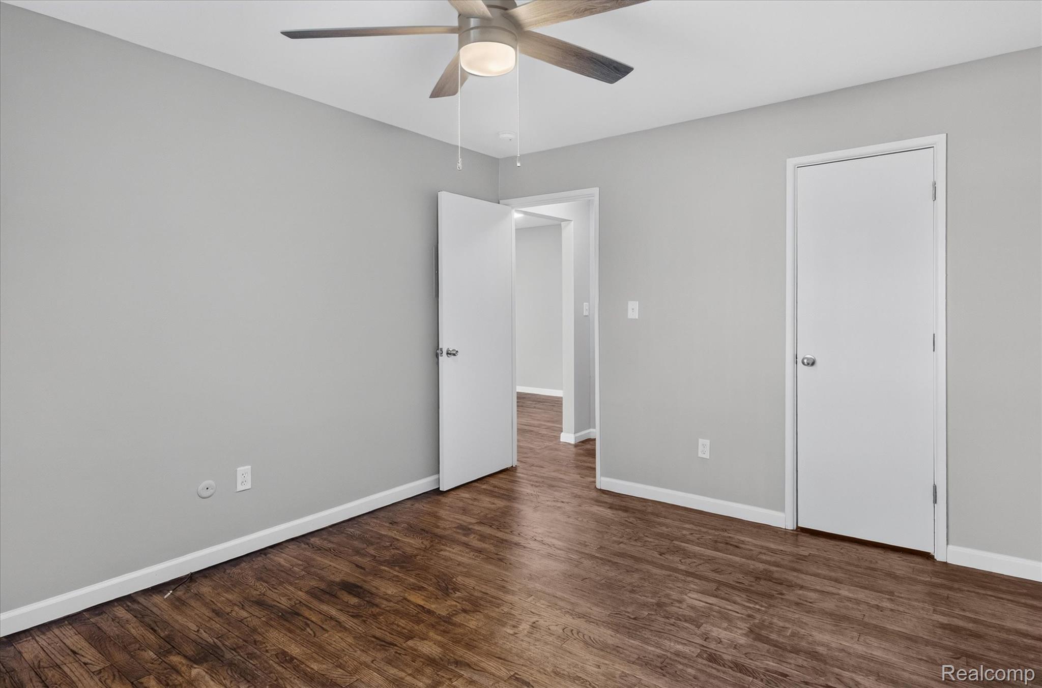 32650 Mound Road, Unit 4 Warren, MI 48092 - Photo 15 of 32 Wood-finish flooring with light gray walls, white trim, and a ceiling fan