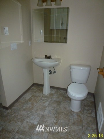 22010 7th Place West Bothell, WA 98021 - Photo 11 of 15 a bathroom with a toilet a sink and mirror