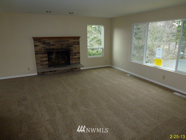 22010 7th Place West Bothell, WA 98021 - Photo 3 of 15 an empty room with windows and fireplace