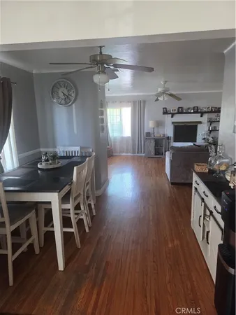 a dining room with furniture and wooden floor