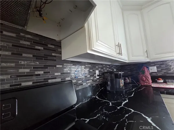 a kitchen with a sink stainless steel appliances and cabinets