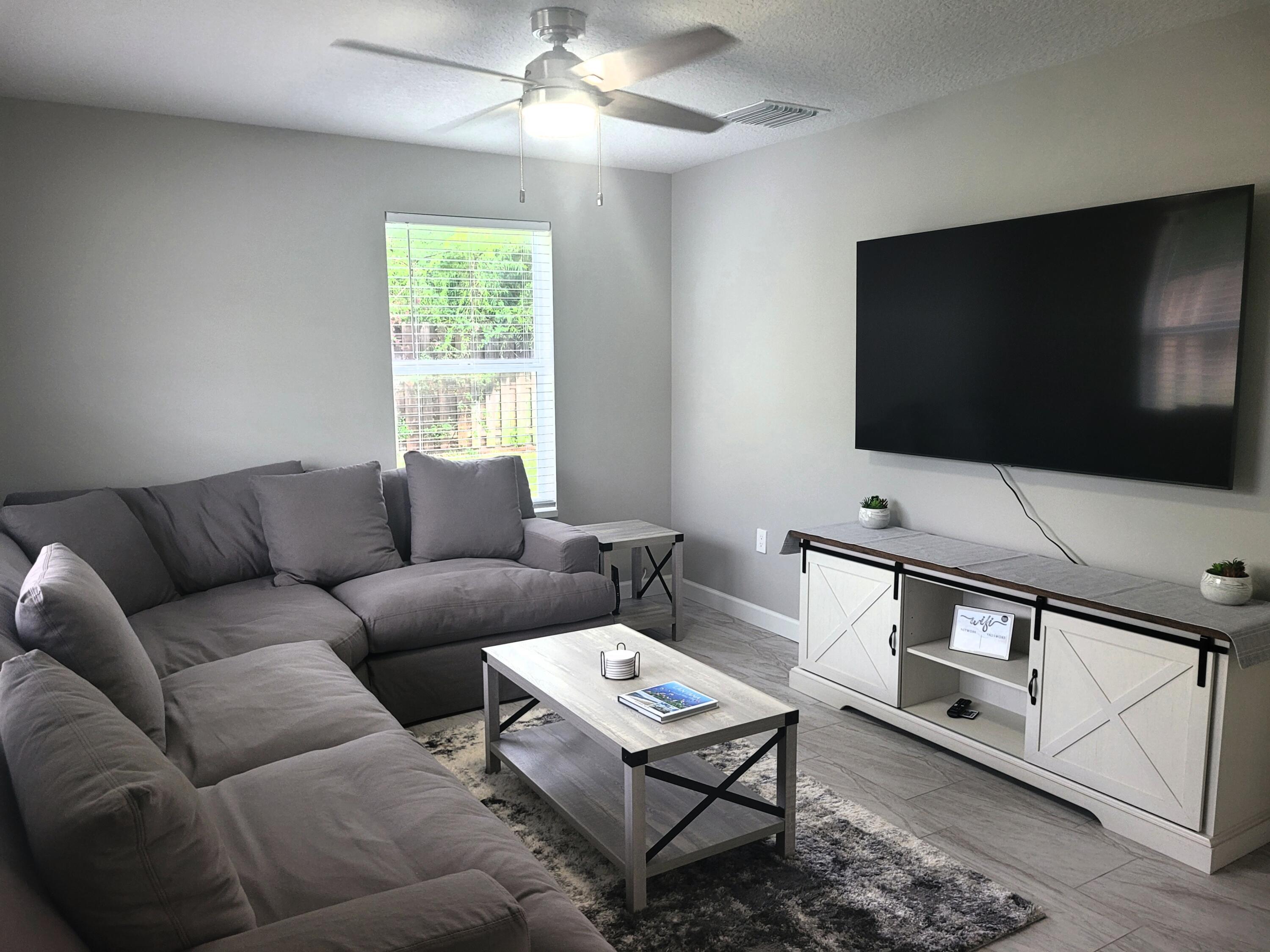 511 West Pine Street, Unit B Lantana, FL 33462 - Photo 1 of 11 a living room with furniture a flat screen tv and a window