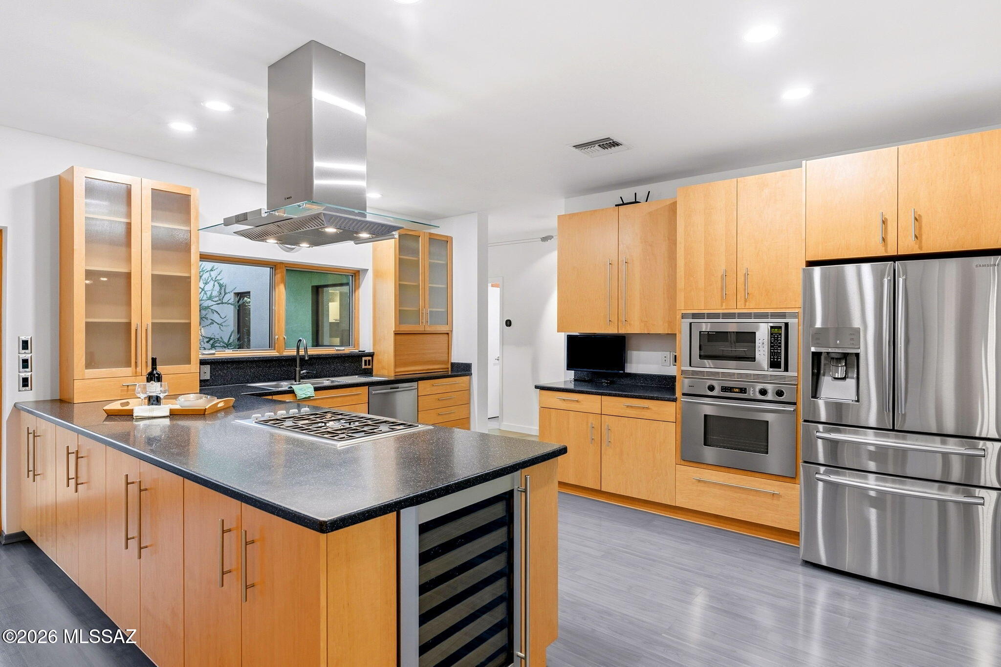 5070 North Valley View Road Tucson, AZ 85718 - Photo 15 of 51 a kitchen with kitchen island granite countertop stainless steel appliances a sink stove and refrigerator