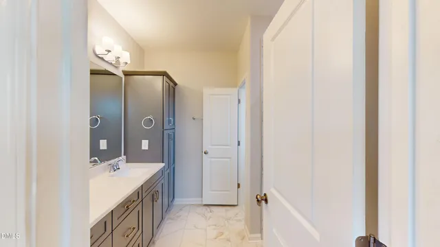 a spacious bathroom with a double vanity sink and a mirror