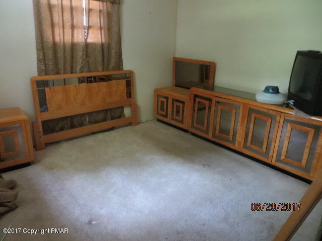 110 Firehouse Road Pocono Pines, PA 18350 - Photo 3 of 8 a view of a room with furniture and a window