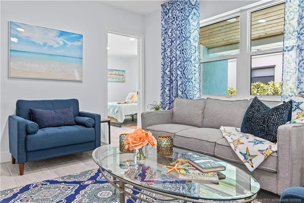 a living room with furniture and a large window