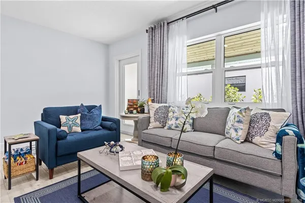 a dining room with furniture and a wooden floor