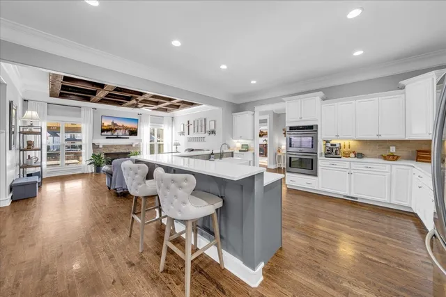 a living room with furniture and kitchen view