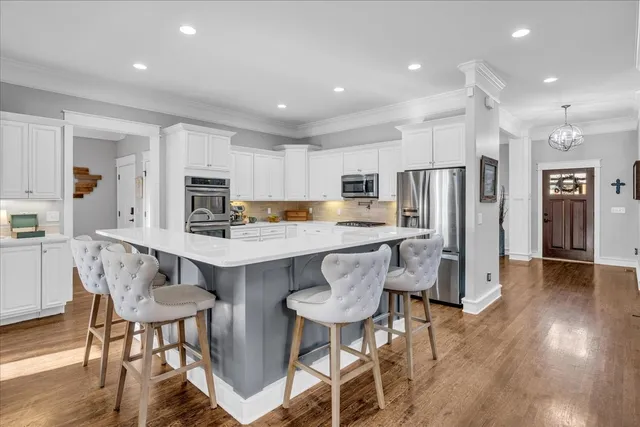 a bedroom with a bed and a flat tv screen on the dresser