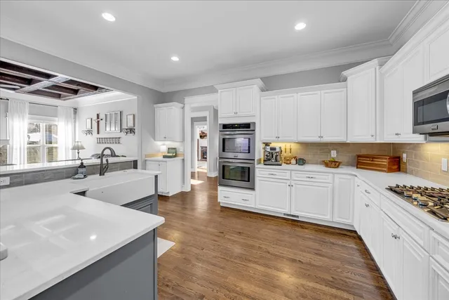 a spacious bathroom with a granite countertop sink a mirror a vanity and a