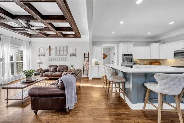 a spacious bedroom with a large bed and a flat tv screen on dresser
