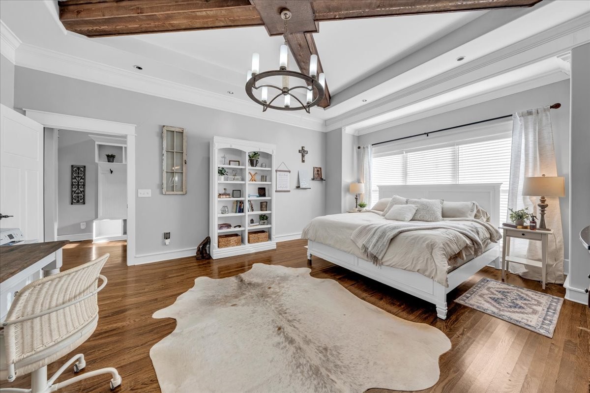 1021 Alice Springs Circle Spring Hill, TN 37174 - Photo 22 of 86 a spacious bedroom with a bed a chandelier and next to a window