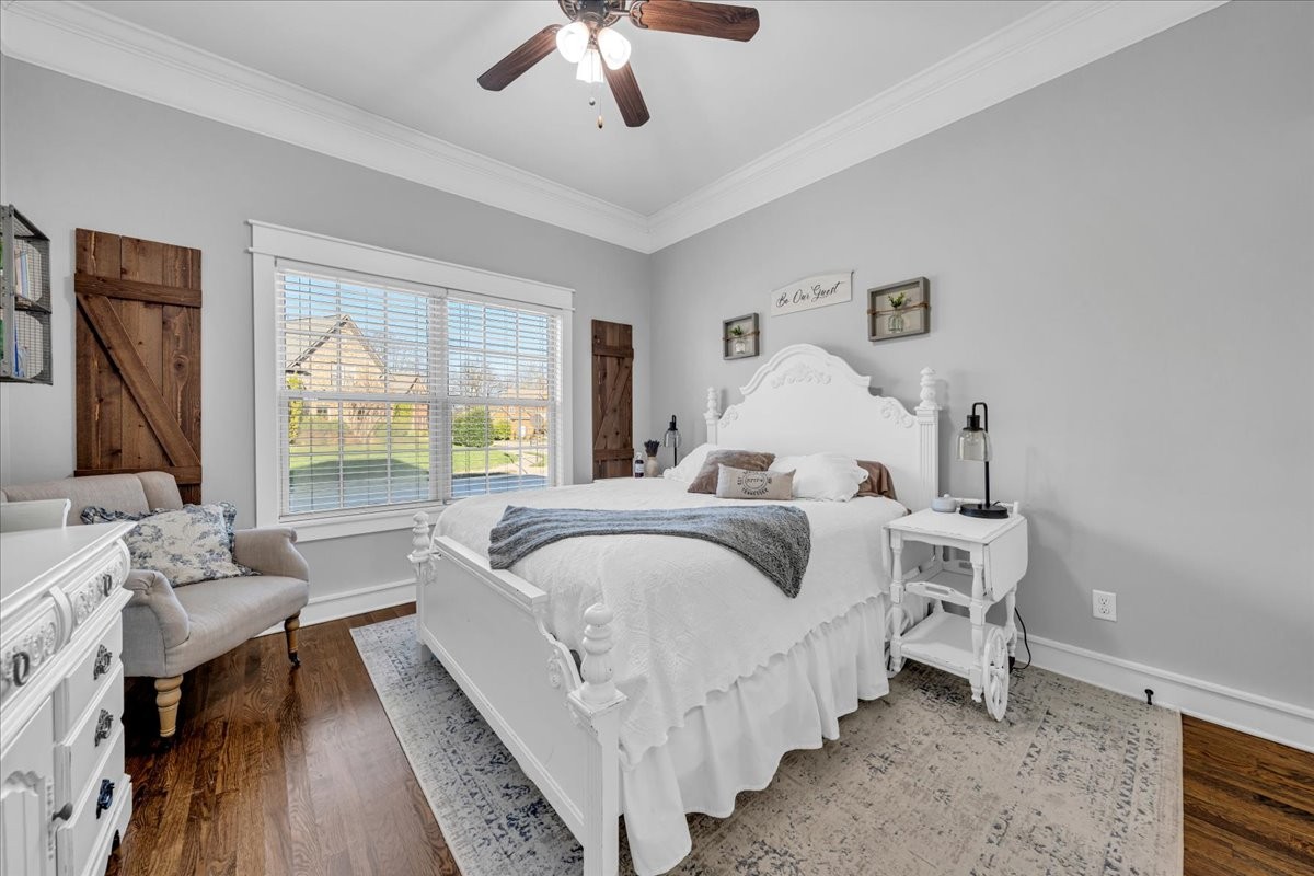1021 Alice Springs Circle Spring Hill, TN 37174 - Photo 25 of 86 a bed room with a bed and a chandelier