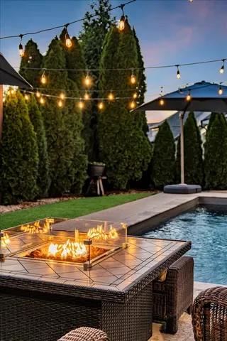 a view of swimming pool with a yard and sitting area