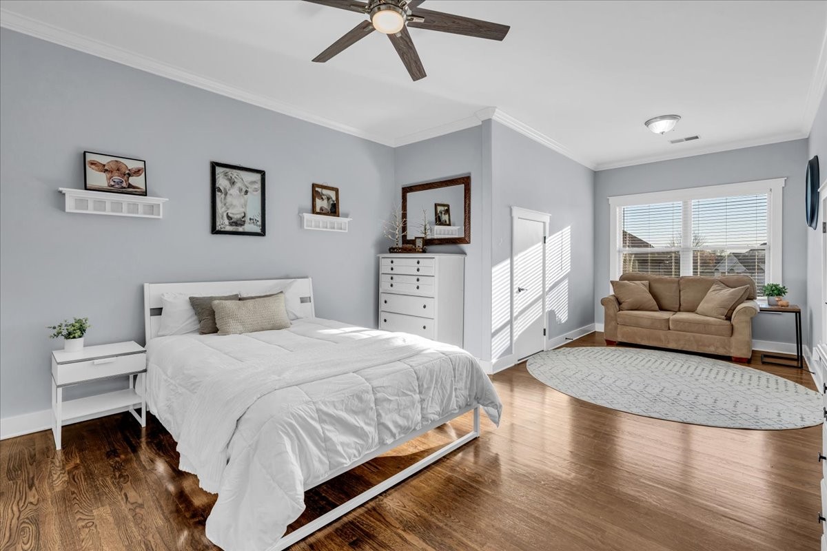 1021 Alice Springs Circle Spring Hill, TN 37174 - Photo 31 of 86 a bedroom with a large bed a couch and a window