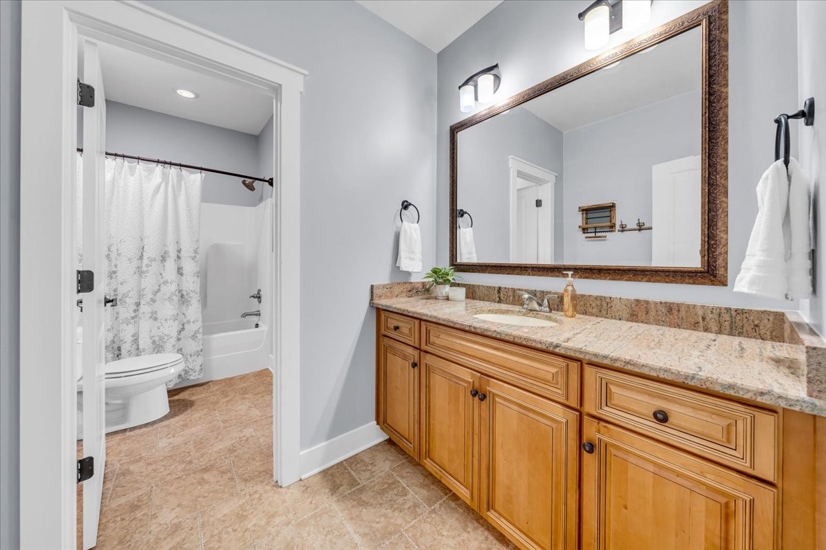 1021 Alice Springs Circle Spring Hill, TN 37174 - Photo 35 of 86 a spacious bathroom with a granite countertop sink mirror and shower
