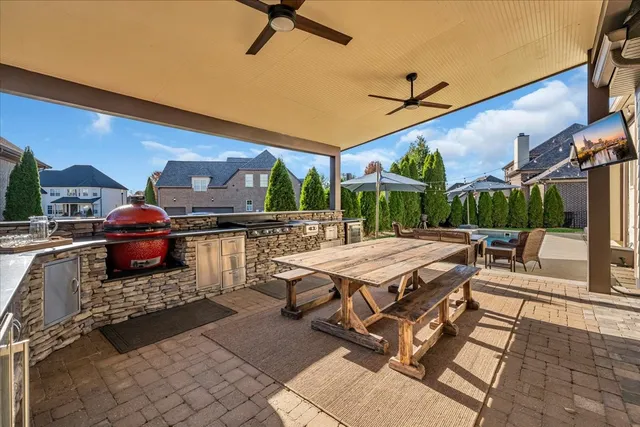 a kitchen with stainless steel appliances granite countertop a sink and a refrigerator