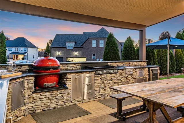 a kitchen with stainless steel appliances granite countertop white cabinets and a stove top oven
