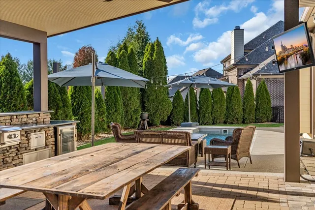 a large kitchen with a sink stove and refrigerator