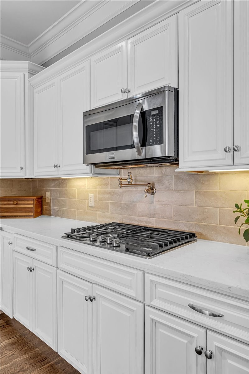 1021 Alice Springs Circle Spring Hill, TN 37174 - Photo 78 of 86 a kitchen with stainless steel appliances granite countertop white cabinets and a stove top oven