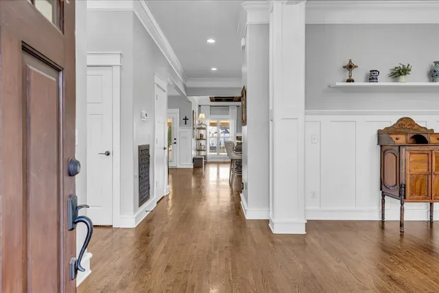 a kitchen with stainless steel appliances a dining table chairs refrigerator and microwave