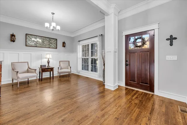 a living room with furniture large window and a fireplace