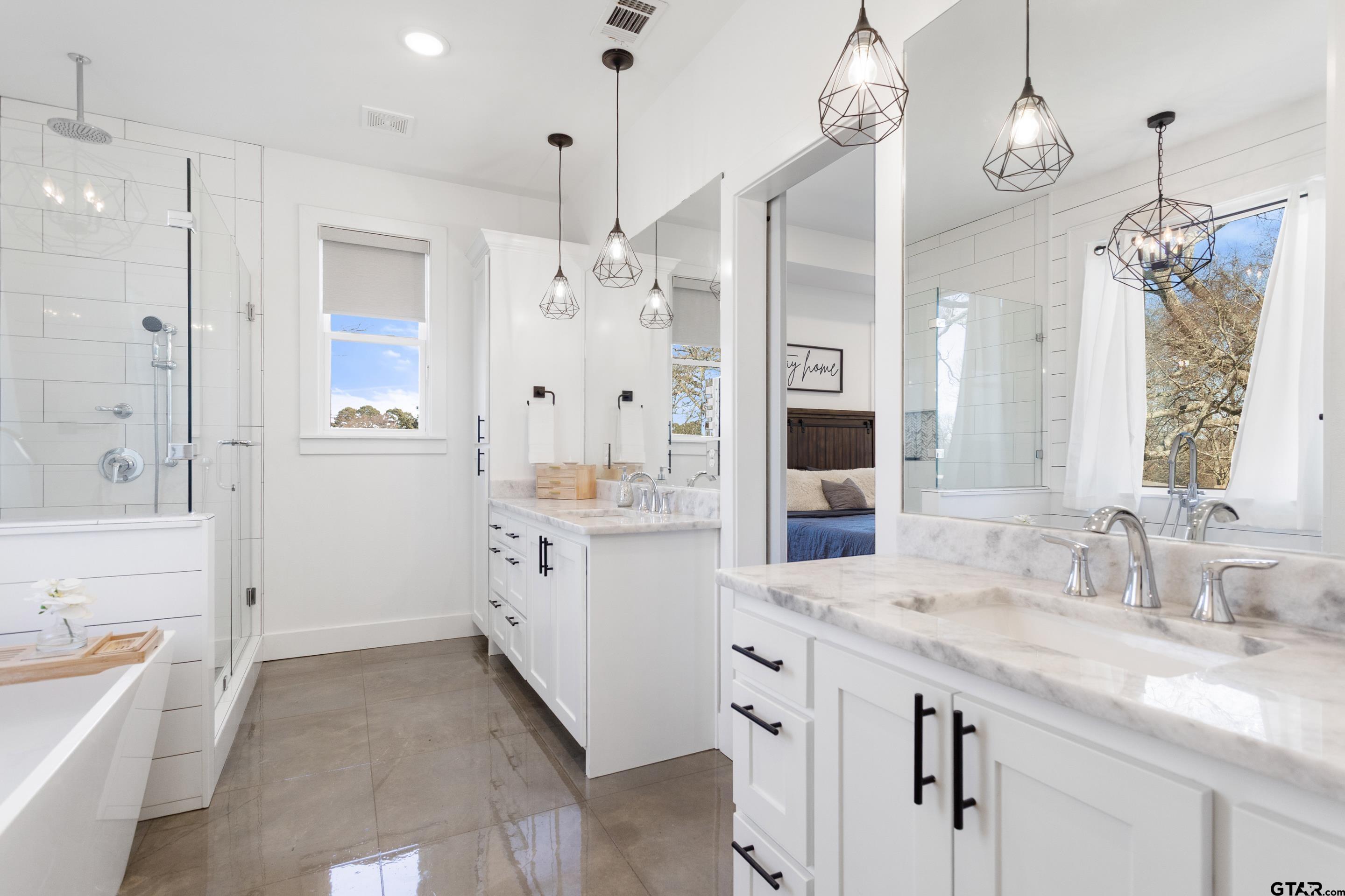 15344 County Road 196 Tyler, TX 75703 - Photo 19 of 48 a spacious bathroom with a granite countertop sink mirror and a shower
