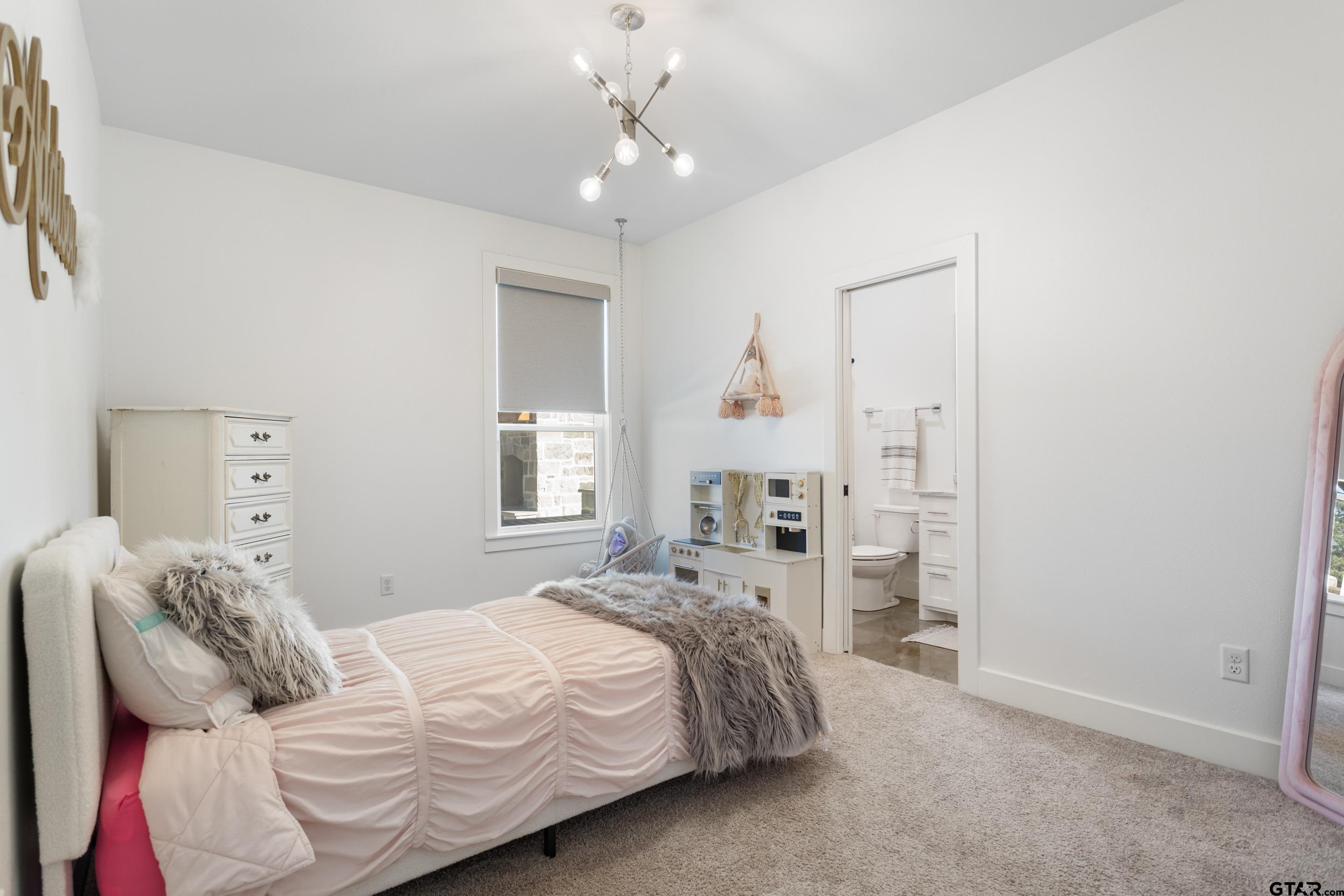 15344 County Road 196 Tyler, TX 75703 - Photo 24 of 48 a bedroom with a bed and a chandelier