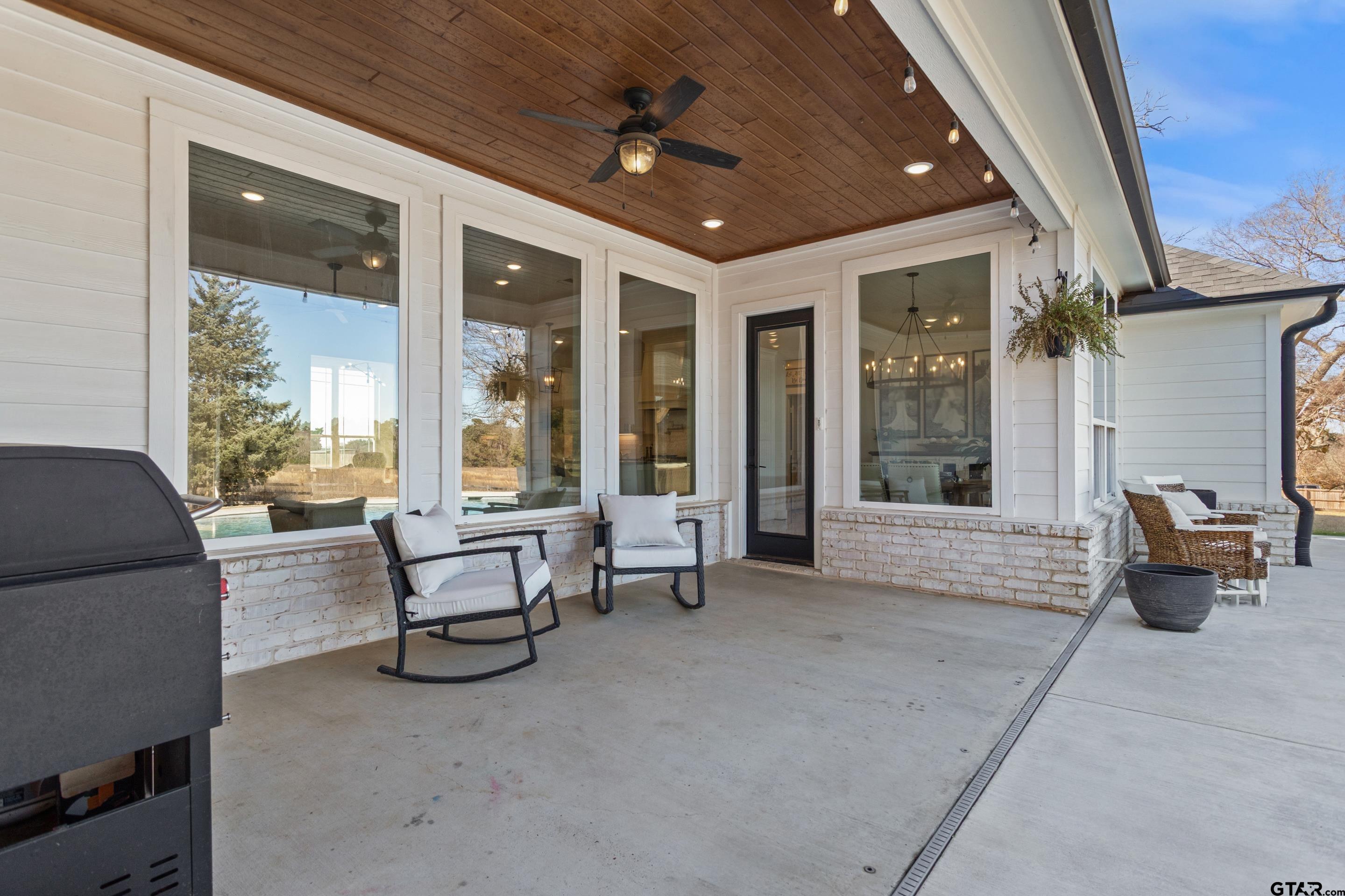 15344 County Road 196 Tyler, TX 75703 - Photo 30 of 48 a living room with furniture and a floor to ceiling window