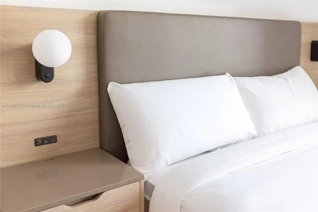 a bedroom with a bed and cabinets