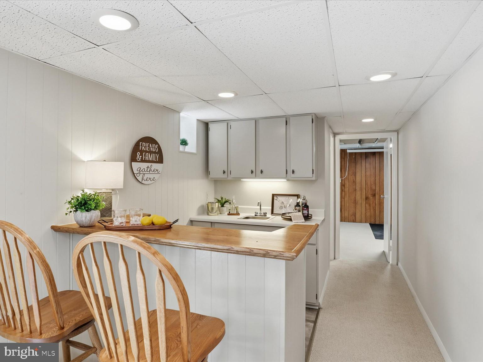 5903 Oak Ridge Court Burke, VA 22015 - Photo 36 of 54 Wet bar with sink and beverage fridge