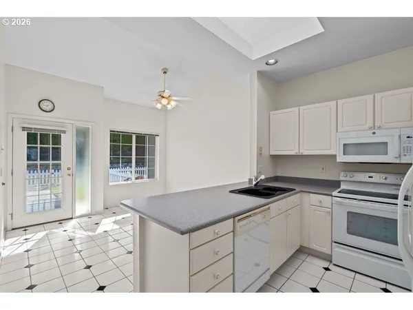 a kitchen with granite countertop a stove a sink and a granite counter tops