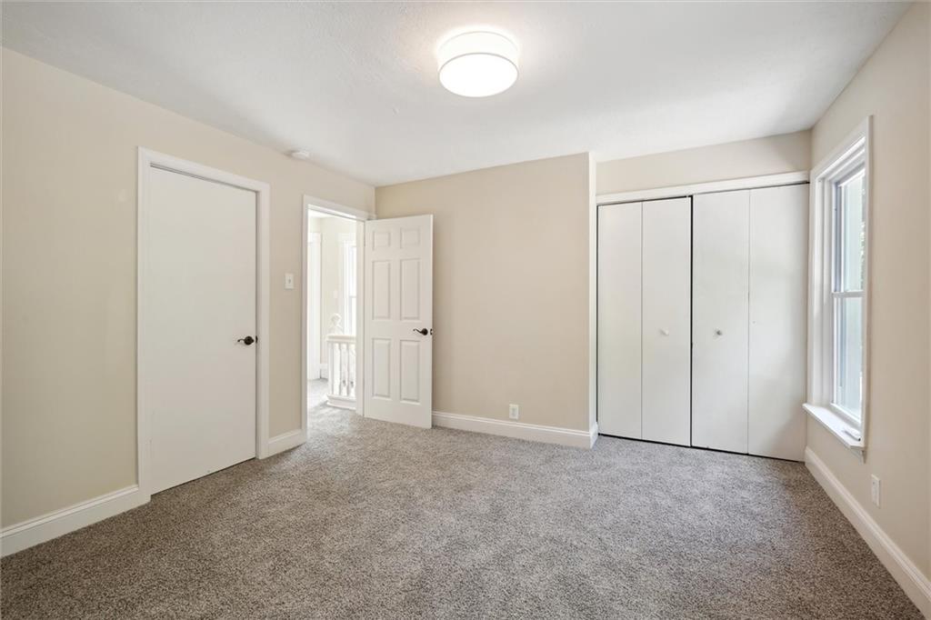 422 Grove Street McKees Rocks, PA 15136 - Photo 20 of 35 The primary bedroom features 3 closets with organizers, new carpet, new dry wall + insulation, new windows, and fresh paint.