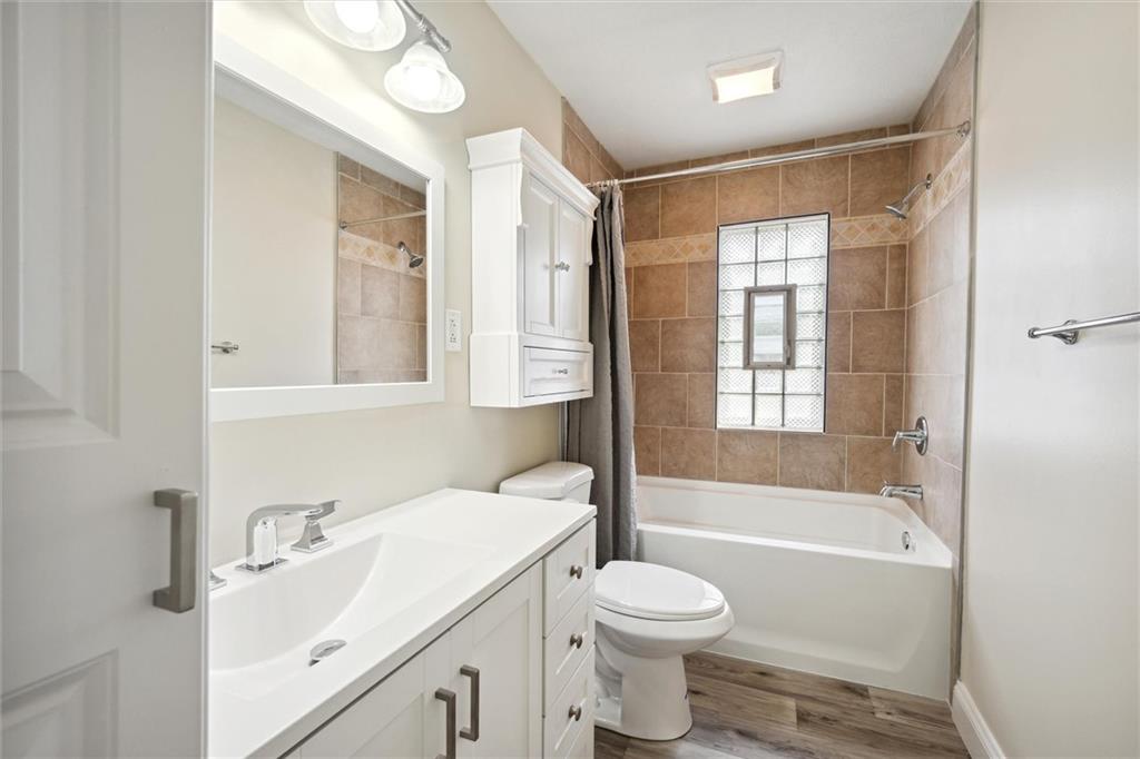 422 Grove Street McKees Rocks, PA 15136 - Photo 21 of 35 The upper level hall bath is completely renovated with a deep soak tub & shower, surround tile, new vanity, sink, lights, fixtures, and floor.