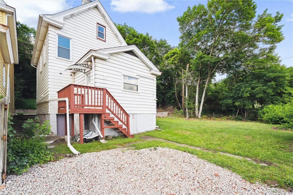 422 Grove Street McKees Rocks, PA 15136 - Photo 28 of 35 The back yard with gravel driveway provides plenty of parking. Easy access into the kitchen.