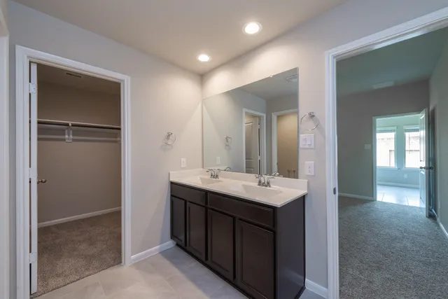a bathroom with a double vanity sink and mirror