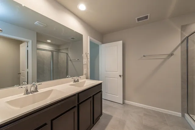a bathroom with a double vanity sink and a mirror