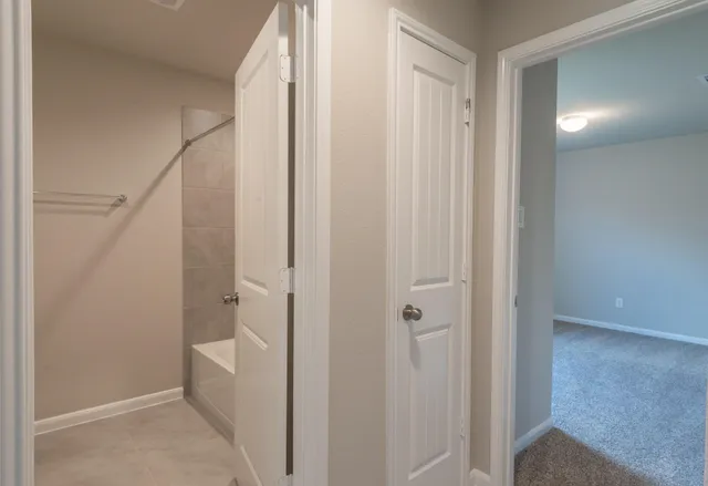 a bathroom with a shower and a sink